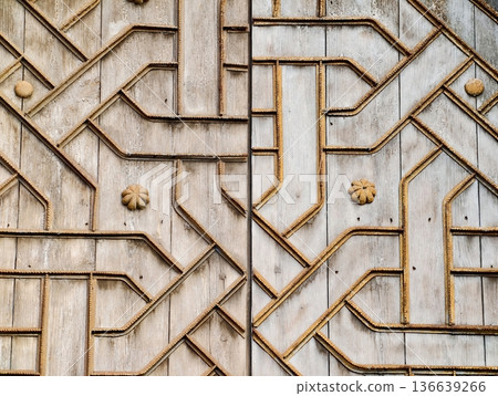Decorative Carved Wooden Door, Detailed Carved Wooden Door Featuring Weathered Patina And Brass Studs Decorative Carved Wooden Door, Detailed Carved Wooden Door Featuring Weathered Patina And Brass Studs 136639266