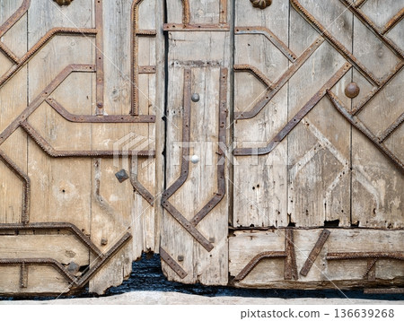 Antique Crafted Entrance With Age, Weathered Timber Door Showcasing Craftsmanship And Timeless Charm Antique Crafted Entrance With Age, Weathered Timber Door Showcasing Craftsmanship And Timeless Charm 136639268