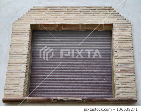 Industrial Storefront Appearance, Textured Metallic Shutter Combined With Rustic Brick Archway Industrial Storefront Appearance, Textured Metallic Shutter Combined With Rustic Brick Archway 136639271