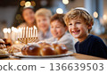 Children celebrating Hanukkah with a joyful atmosphere, enjoying traditional food and a menorah in a festive indoor setting 136639503