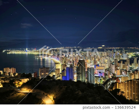 Calm Bay Under Starry Sky, Serene Evening With Still Waters And Distant City Lights Glowing Softly Calm Bay Under Starry Sky, Serene Evening With Still Waters And Distant City Lights Glowing Softly 136639524