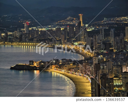 Sunny Shoreline With Lively Lights, Nighttime Coastal Walkway Illuminated With Vibrant Streetlights Sunny Shoreline With Lively Lights, Nighttime Coastal Walkway Illuminated With Vibrant Streetlights 136639537