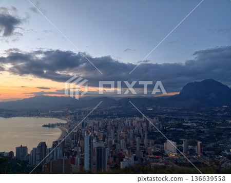 Urban Coastline With Vibrant Evening Sky, Distant Mountains Frame Peaceful Harbor During Sunset Hours Urban Coastline With Vibrant Evening Sky, Distant Mountains Frame Peaceful Harbor During Sunset Hours 136639558