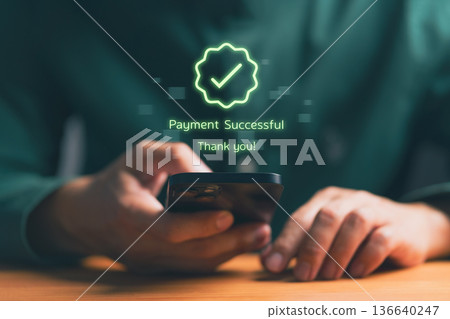 Person holding smartphone with digital confirmation message Payment Successful, representing online transaction, mobile banking, e-commerce payment, fintech technology, and secure financial service. Person holding smartphone with digital confirmation message Payment Successful, representing online transaction, mobile banking, e-commerce payment, fintech technology, and secure financial service. 136640247