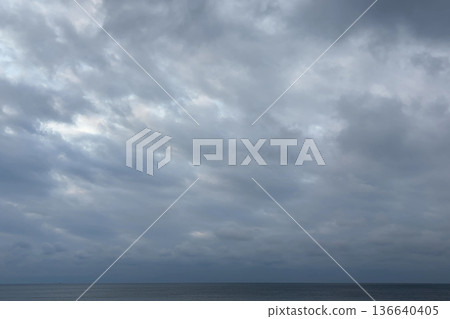 A winter sea covered in thick clouds and a quiet horizon A winter sea covered in thick clouds and a quiet horizon 136640405