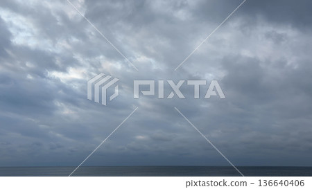 冬日的大海被厚厚的雲層覆蓋,地平線一片靜謐。 冬日的大海被厚厚的雲層覆蓋,地平線一片靜謐。 136640406
