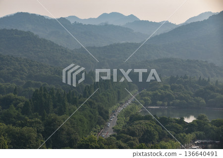 A road going through forested mountains outside Hangzhou in China A road going through forested mountains outside Hangzhou in China 136640491