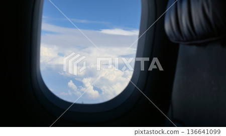 Scenery outside the window of a passenger plane, beautiful blue sky and white cloud view 136641099