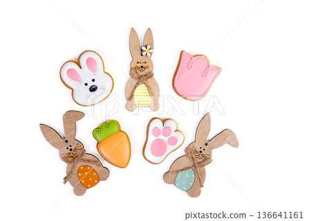 Colorful Easter cookies and the wooden decor on white background. Colorful Easter cookies and the wooden decor on white background. 136641161