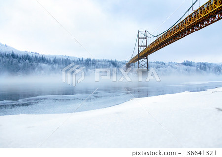 Steel and concrete bridge across the foggy river in winter. Steel and concrete bridge across the foggy river in winter. 136641321