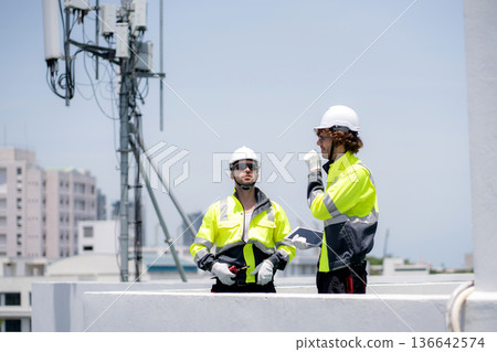 Technician team talking collaboration working about communication transmitter system. Technician team talking collaboration working about communication transmitter system. 136642574