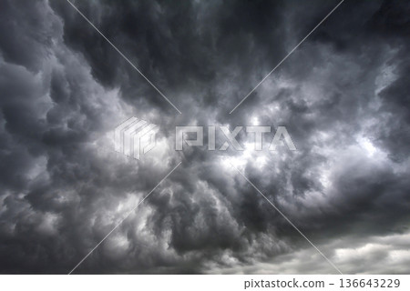Dramatic dark storm rain clouds black sky background. Dark thunderstorm clouds rainny atmosphere. Meteorology danger windstorm disasters climate. Dark cloudscape storm disaster gloomy gray cloud sky Dramatic dark storm rain clouds black sky background. Dark thunderstorm clouds rainny atmosphere. Meteorology danger windstorm disasters climate. Dark cloudscape storm disaster gloomy gray cloud sky 136643229