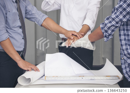 Close up engineer men hands diversity multiethnic partners team together. Group of multiracial people Engineer Manager Foreman Teamwork meeting join hands. Top view office table team join partnership Close up engineer men hands diversity multiethnic partners team together. Group of multiracial people Engineer Manager Foreman Teamwork meeting join hands. Top view office table team join partnership 136643250
