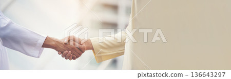 Banner Arab Businessman Muslim dress shaking hands together. Panorama Muslim Men Teamwork business partner handshake teams Partnership. multiracial UAE diversity  people trust honesty with copy space 136643297