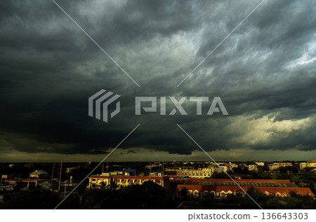 Dramatic dark storm rain clouds black sky background. Dark thunderstorm clouds rainny atmosphere. Meteorology danger windstorm disasters climate. Dark cloudscape storm disaster gloomy gray cloud sky Dramatic dark storm rain clouds black sky background. Dark thunderstorm clouds rainny atmosphere. Meteorology danger windstorm disasters climate. Dark cloudscape storm disaster gloomy gray cloud sky 136643303