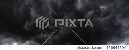 Banner Dramatic dark storm clouds black sky background. Dark thunderstorm clouds rainny season. Panorama Meteorology danger windstorm disasters climate. Dark cloudscape storm cloud with copy space. Banner Dramatic dark storm clouds black sky background. Dark thunderstorm clouds rainny season. Panorama Meteorology danger windstorm disasters climate. Dark cloudscape storm cloud with copy space. 136643304