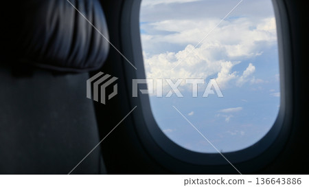 Scenery outside the window of a passenger plane, beautiful blue sky and white cloud view Scenery outside the window of a passenger plane, beautiful blue sky and white cloud view 136643886
