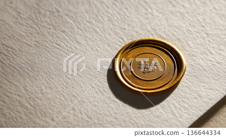 Luxury branding concept with gold wax seal stamped on textured paper Luxury branding concept with gold wax seal stamped on textured paper 136644334
