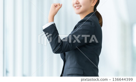 Young woman/businesswoman doing a fist pump Young woman/businesswoman doing a fist pump 136644399