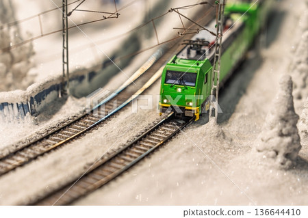 Miniature Green Train on Snowy Tracks A Detailed Model Railroad Scene for Enthusiasts Miniature Green Train on Snowy Tracks A Detailed Model Railroad Scene for Enthusiasts 136644410