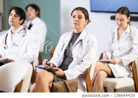 young woman participates in a conference for young doctors young woman participates in a conference for young doctors 136644420