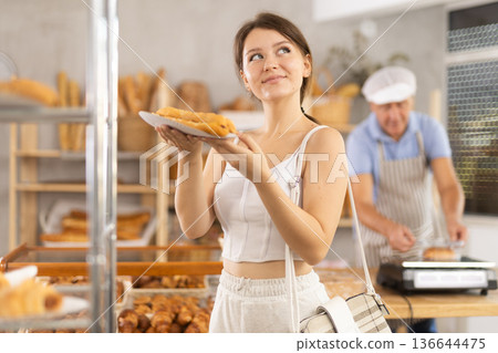 Young woman buyer with bocadillo in bakery 136644475