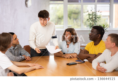 Group of men discussing something at the desk 136644515