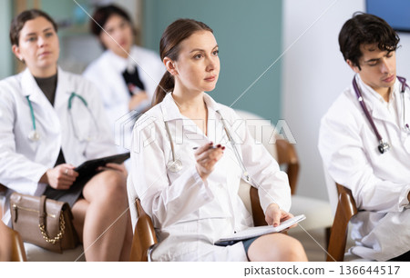 Woman doctor participates in training and listens to a lecture Woman doctor participates in training and listens to a lecture 136644517