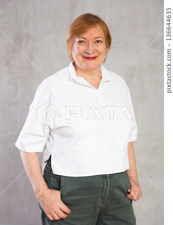 Older woman standing proudly with happy confident grin 136644635