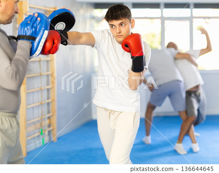 Two men training boxing fight in studio Two men training boxing fight in studio 136644645