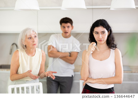 Mom and older brother scold young crying girl for unsuccessful studies at university 136644647