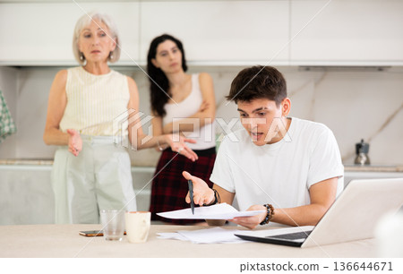 Mom and wife scold her husband for playing computer games Mom and wife scold her husband for playing computer games 136644671