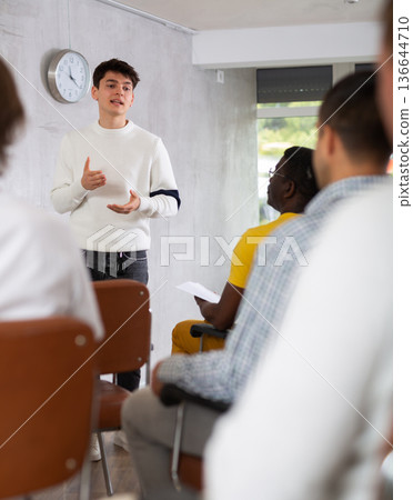 Young student presenting report to group of male students Young student presenting report to group of male students 136644710