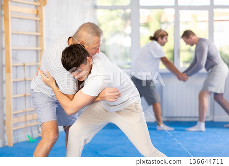 Young and elderly men training judo fight 136644711