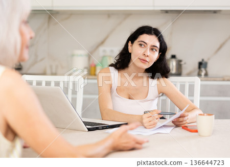 Mature woman meeting financial advisor for investment at home 136644723