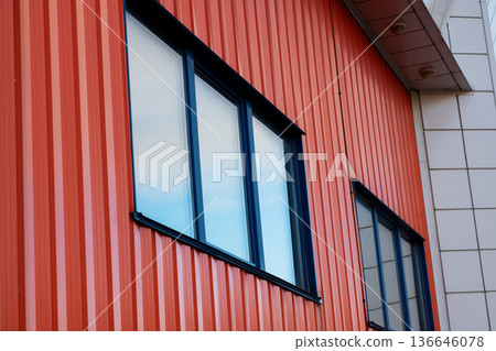 Contemporary urban structure featuring bright reflective windows and clean lines 136646078
