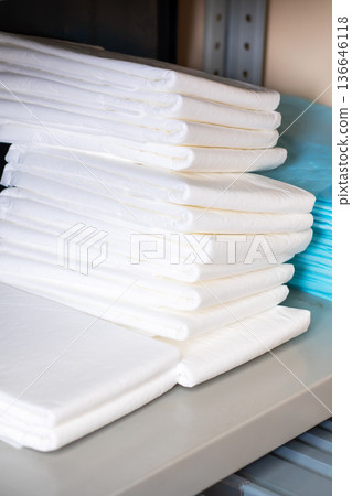 Sterile hospital towels systematically stacked on metal shelves for quick access and distribution Sterile hospital towels systematically stacked on metal shelves for quick access and distribution 136646118
