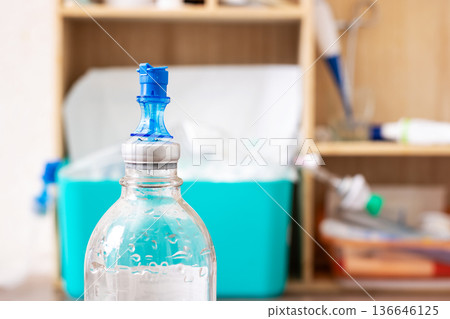 Medical setting with saline bottle underscores healthcare safety measures importance Medical setting with saline bottle underscores healthcare safety measures importance 136646125