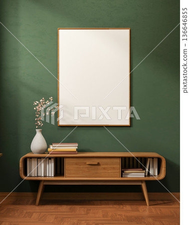 White frame on dark green wall over flower vase and book on drawer table on wooden tiles floor room. 136646855