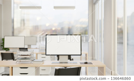 Blank screen computer and document on wooden drawer table and chair in office company workplace room 136646860