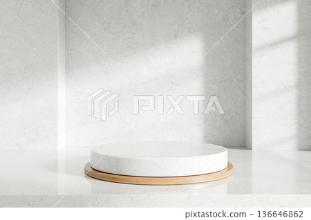 Empty round display platform over wooden tray on white marble counter and sunlight shining on a wall 136646862