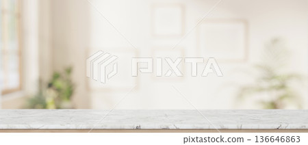 Empty marble tabletop across blank frame on white wall in a living room with sunlight through window 136646863