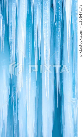Frozen Icicles Hanging with Blue Tint and Clear Texture in a Cold Winter Day 136647175