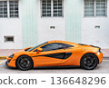 Miami, Florida, USA - July 27, 2025: McLaren 570S 2017 sportscar supercar coupe car. Luxury sport car McLaren 570S. Car McLaren 570S parked outdoor. Orange sportscar, side view. 136648296