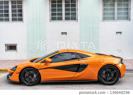 Miami, Florida, USA - July 27, 2025: McLaren 570S 2017 sportscar supercar coupe car. Luxury sport car McLaren 570S. Car McLaren 570S parked outdoor. Orange sportscar, side view. Miami, Florida, USA - July 27, 2025: McLaren 570S 2017 sportscar supercar coupe car. Luxury sport car McLaren 570S. Car McLaren 570S parked outdoor. Orange sportscar, side view. 136648296