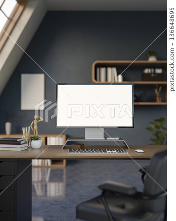 White screen computer and books on wooden table with swivel chair on granite floor in dark blue room 136648695