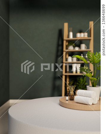 Towel and diffuser with essential oil on tray over table across wooden shelf in dark green wall room 136648699