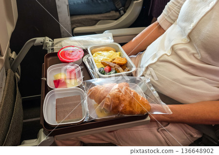 SImple airline flight meal served on serving tray of economy class sector 136648902