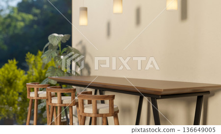 Wooden stool chairs and table under hanging lamps and white wall in a corner with houseplant or garden. Wooden stool chairs and table under hanging lamps and white wall in a corner with houseplant or garden. 136649005