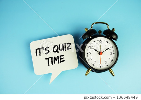 It's Quiz Time text on speech bubble with alarm clock on blue background It's Quiz Time text on speech bubble with alarm clock on blue background 136649449